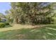 Large backyard with mature trees and green grass at 1645 Highpoint Rd, Snellville, GA 30078