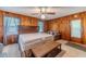 Bedroom with wood paneled walls and king bed at 1645 Highpoint Rd, Snellville, GA 30078