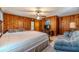 Bedroom with wood paneled walls and king bed at 1645 Highpoint Rd, Snellville, GA 30078