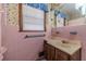Pink tiled bathroom with a vanity and shower at 1645 Highpoint Rd, Snellville, GA 30078