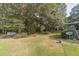 Spacious backyard with mature trees and lush lawn at 1645 Highpoint Rd, Snellville, GA 30078