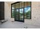 Back patio with French doors and light brick wall at 8200 Main S St # 1306, Woodstock, GA 30188