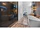 Spa-like bathroom with soaking tub, glass shower, and modern fixtures at 8200 Main S St # 1306, Woodstock, GA 30188