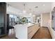 Modern kitchen with white and light wood cabinetry, large island, and high-end appliances at 3107 Peachtree Ne Rd # 1101, Atlanta, GA 30305