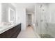 Elegant bathroom featuring a soaking tub, walk-in shower, and double vanity with marble countertops at 3107 Peachtree Ne Rd # 1101, Atlanta, GA 30305