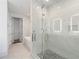 Spa-like bathroom with a glass enclosed shower, marble tile, and modern fixtures at 3107 Peachtree Ne Rd # 1101, Atlanta, GA 30305