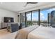 Bright bedroom with a king-size bed and stunning city views from floor-to-ceiling windows at 3107 Peachtree Ne Rd # 1101, Atlanta, GA 30305