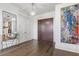 Bright and airy entryway with hardwood floors, modern console table, and large art piece at 3107 Peachtree Ne Rd # 1101, Atlanta, GA 30305