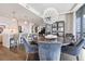 Modern dining room with round table, blue velvet chairs, and a large chandelier at 3107 Peachtree Ne Rd # 1101, Atlanta, GA 30305