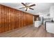 Living room with wood paneled walls and hardwood floors at 4440 Stonewall Tell Rd, Atlanta, GA 30349