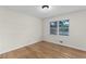Spacious bedroom with hardwood floors and large window at 4440 Stonewall Tell Rd, Atlanta, GA 30349