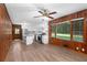 Open concept living room with wood paneling and kitchen view at 4440 Stonewall Tell Rd, Atlanta, GA 30349