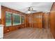 Dining area with wood paneled walls and hardwood floors at 4440 Stonewall Tell Rd, Atlanta, GA 30349