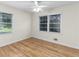 Bedroom with hardwood floors, ceiling fan and large window at 4440 Stonewall Tell Rd, Atlanta, GA 30349