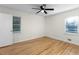 Bedroom with hardwood floors, two windows and ceiling fan at 4440 Stonewall Tell Rd, Atlanta, GA 30349
