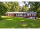Ranch style brick home on a large lot with a grassy yard at 4440 Stonewall Tell Rd, Atlanta, GA 30349