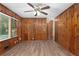 Living room with wood paneled walls and hardwood floors at 4440 Stonewall Tell Rd, Atlanta, GA 30349