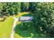 Aerial view of a ranch house with a large yard and driveway at 4440 Stonewall Tell Rd, Atlanta, GA 30349