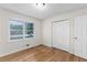 Bedroom with hardwood floors, double closet, and window at 4440 Stonewall Tell Rd, Atlanta, GA 30349