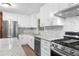 Renovated kitchen with white shaker cabinets, granite countertops, and stainless steel appliances at 4440 Stonewall Tell Rd, Atlanta, GA 30349