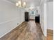 Open concept dining area with wood-look tile floors and kitchen view at 5084 Valley Lake Rd, Austell, GA 30106