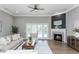 Comfortable living room with hardwood floors, fireplace, and large windows at 12 Ivy Chase Nw Way, Cartersville, GA 30121