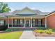 Brick house with a covered porch, black shutters, and a manicured lawn at 12 Ivy Chase Nw Way, Cartersville, GA 30121