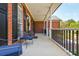 Spacious covered porch with brick flooring and comfortable seating area at 12 Ivy Chase Nw Way, Cartersville, GA 30121