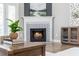 Elegant fireplace with decorative tile surround and a cozy fire at 12 Ivy Chase Nw Way, Cartersville, GA 30121