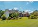 Brick and siding house with a large yard and landscaping at 12 Ivy Chase Nw Way, Cartersville, GA 30121