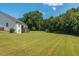 Large backyard with neatly mowed lawn and wooden fence at 12 Ivy Chase Nw Way, Cartersville, GA 30121