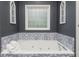 Bathroom with soaking tub and patterned tile accents at 12 Ivy Chase Nw Way, Cartersville, GA 30121