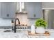 Kitchen island with granite countertop, farmhouse sink, and modern faucet at 12 Ivy Chase Nw Way, Cartersville, GA 30121