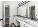 Double vanity bathroom with granite countertop and large mirror at 12 Ivy Chase Nw Way, Cartersville, GA 30121