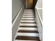 Clean, bright staircase with wood steps and white risers at 6209 Southland Forest Dr, Stone Mountain, GA 30087