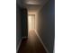 Long hallway with wood-look floors leading to other rooms at 6209 Southland Forest Dr, Stone Mountain, GA 30087