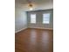 Bright bedroom featuring hardwood floors and dual windows at 6209 Southland Forest Dr, Stone Mountain, GA 30087