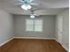 Large bedroom with hardwood floors and ceiling fans at 6209 Southland Forest Dr, Stone Mountain, GA 30087