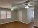 Spacious bedroom with hardwood floors and two ceiling fans at 6209 Southland Forest Dr, Stone Mountain, GA 30087