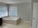 Updated bathroom with soaking tub and hexagon tile floors at 6209 Southland Forest Dr, Stone Mountain, GA 30087