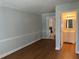 Living room with hardwood floors and access to a half-bathroom at 6209 Southland Forest Dr, Stone Mountain, GA 30087