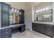 Bathroom with double vanity, large mirror, and extensive cabinetry at 990 Bramlett Shoals Rd, Lawrenceville, GA 30045