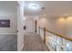 Upstairs hallway with wood railing overlooking the kitchen at 990 Bramlett Shoals Rd, Lawrenceville, GA 30045