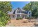 Two-story house with white siding, large windows, and porch at 990 Bramlett Shoals Rd, Lawrenceville, GA 30045