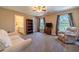 Spacious bedroom with carpeted floor, large windows, and built-in shelving at 990 Bramlett Shoals Rd, Lawrenceville, GA 30045