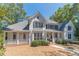 Two-story house with white siding, large windows, and porch at 990 Bramlett Shoals Rd, Lawrenceville, GA 30045