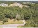 Aerial view of property with wooded lot and neighborhood in the background at 990 Bramlett Shoals Rd, Lawrenceville, GA 30045