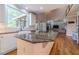 Open concept kitchen with granite island, stainless steel appliances, and hardwood floors at 990 Bramlett Shoals Rd, Lawrenceville, GA 30045