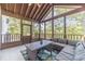 Spacious screened porch provides outdoor living space with wooded views at 990 Bramlett Shoals Rd, Lawrenceville, GA 30045