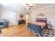 Comfortable bedroom with hardwood floors, ceiling fan and access to en-suite bathroom at 990 Bramlett Shoals Rd, Lawrenceville, GA 30045